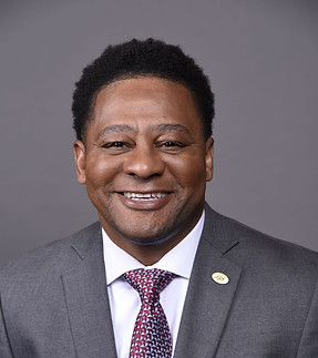 Jeremiah Frazier headshot wearing a suit and tie